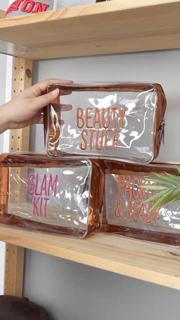 Clear pouches with embroidered lettering, including Beauty Stuff.